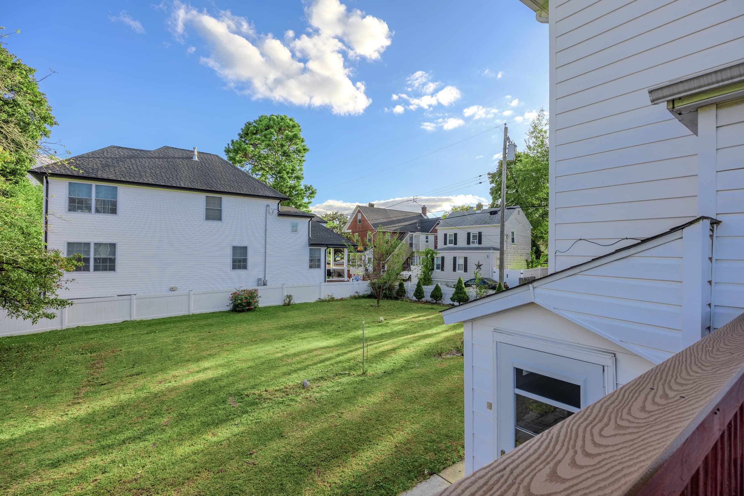 Rear garden and fenced lawn of a Sayreville, NJ single-family home, photographed for listing