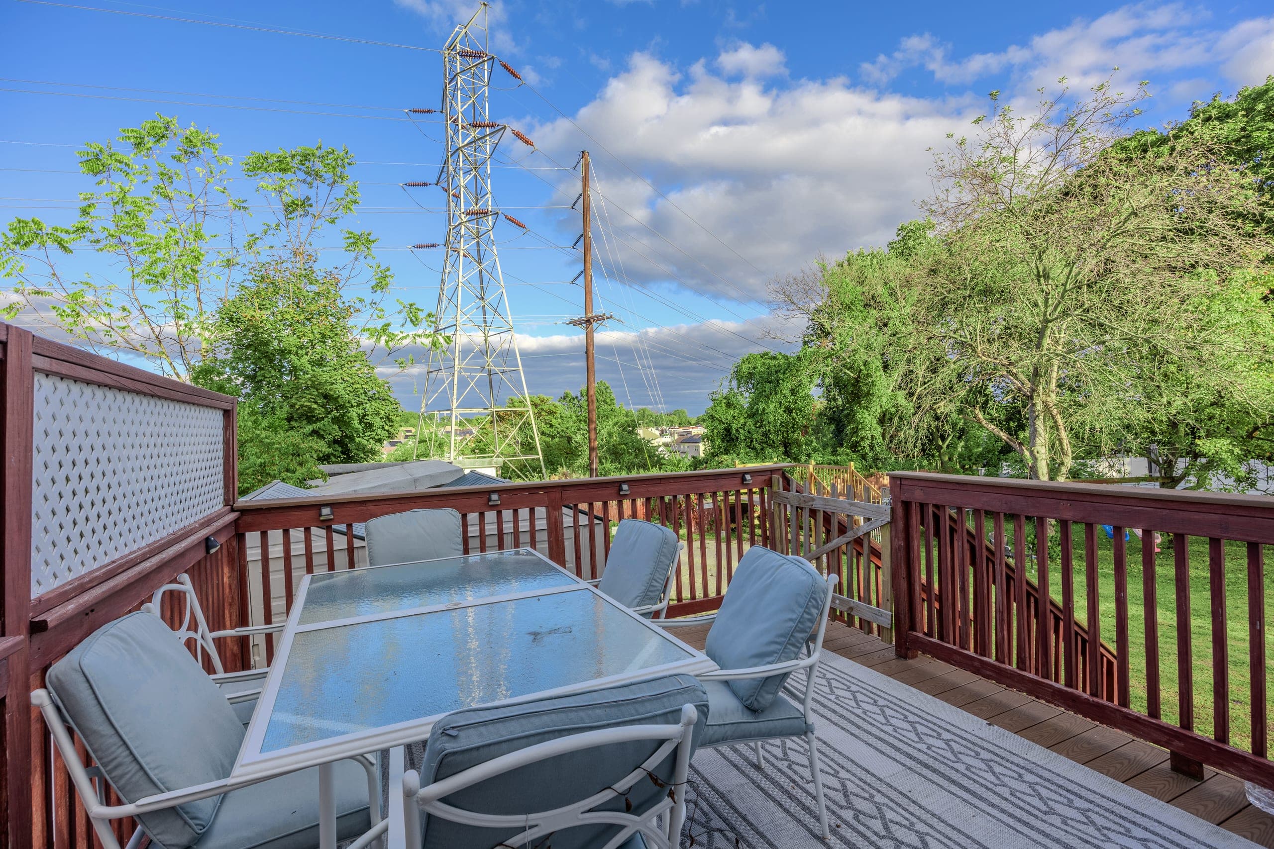 Exterior listing photography of a raised rear deck with outdoor dining space, Sayreville NJ